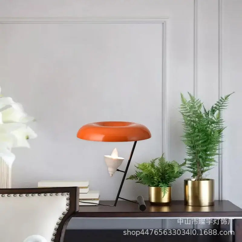 Vibrant orange dome-shaped desk lamp with black metal stand and white ceramic base from decorbites elegant nordic desk series