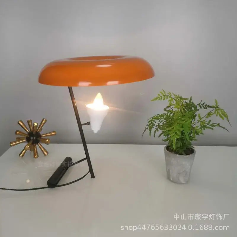 Vibrant orange dome-shaped decorbites elegant nordic desk lamp with black metal stand and white candle-like bulb for bedroom light