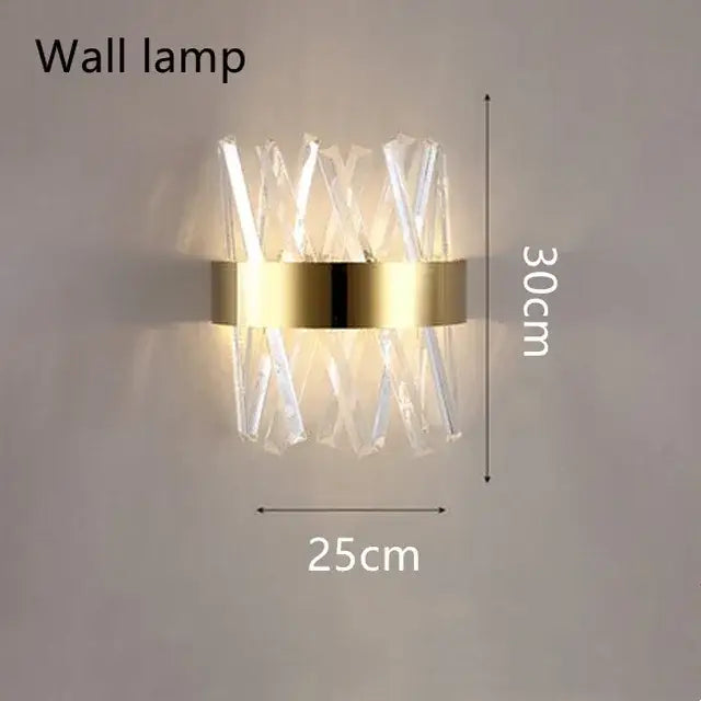 Modern wall lamp with gold-toned circular base and clear crystal rods in x-pattern for elegant decorbites brushed gold decor