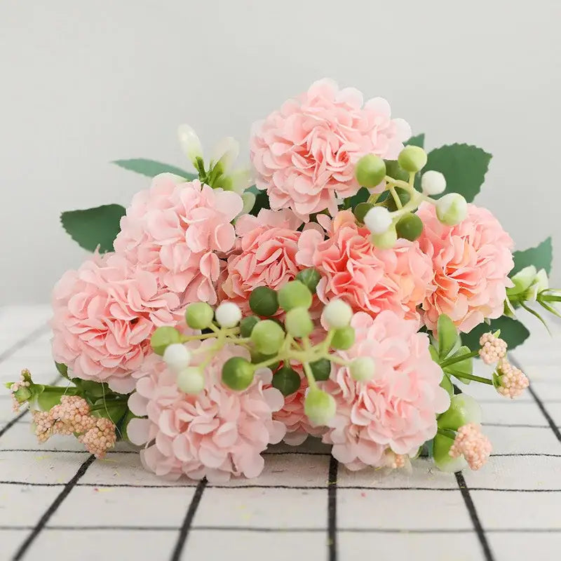 A delicate pink artificial hydrangea decorbites daisy bouquet with green leaves and berries for living room decor