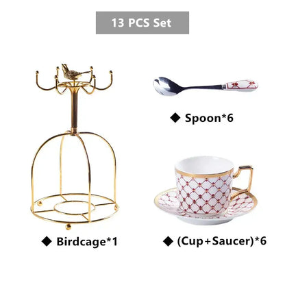 Elegant red and decorbites gold porcelain coffee set featuring a gold birdcage with ornate curved arms and decorative bird