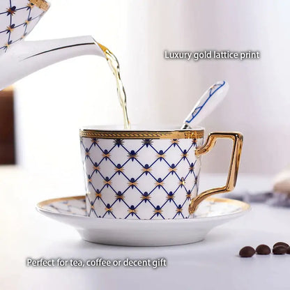 White porcelain teacup with decorbites gold porcelain lattice print navy blue accents and ornate gold handle from elegant red gold coffee set