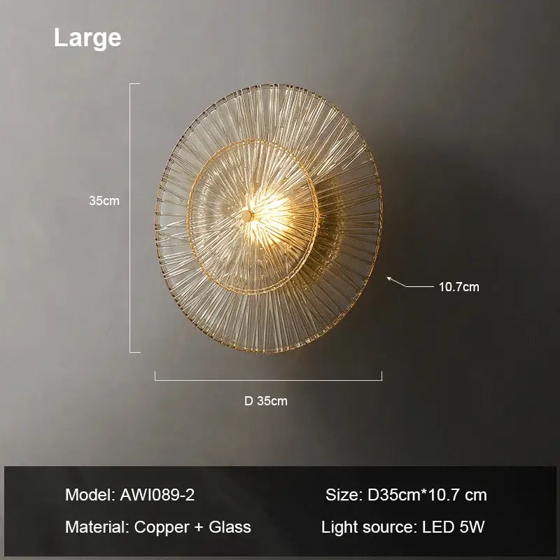 A modern circular wall sconce with layered transparent glass and copper metal framing for elegant glass wall decorbites
