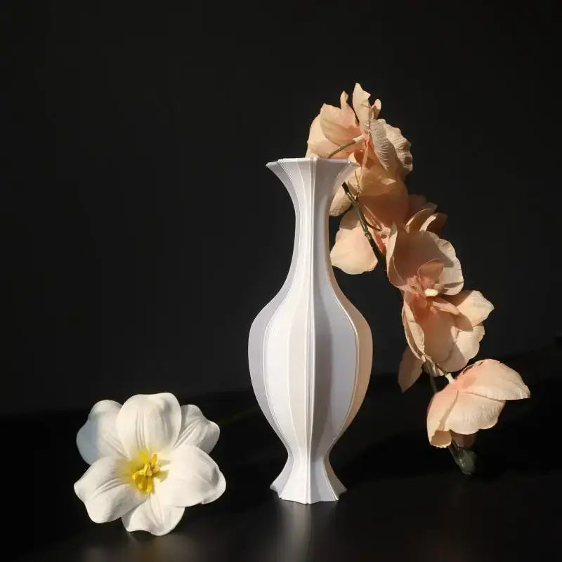 A decorbites elegant high-end white ceramic vase with vertical ridges holding peach orchids and a white lily for living room decor