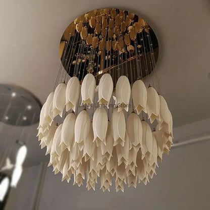 Elegant tulip staircase chandelier with cream-colored frosted glass petals and gold-toned circular ceiling mount by decorbites