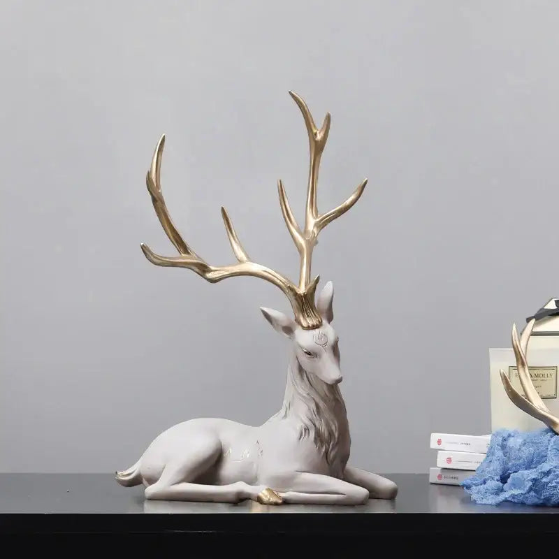 A sleek white ceramic elk figurine with gold antlers and accents decorbites deer sculpture for modern decor