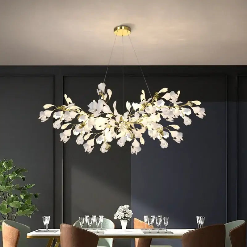 Elegant white and gold ceramic chandelier with ginkgo branch design and gold-toned metal accents for dining room decorbites ginkgo branch
