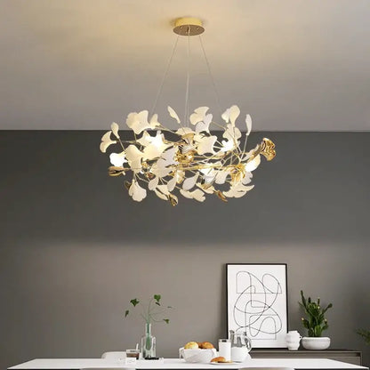 Elegant white and gold ginkgo branch ceramic chandelier with leaf accents suspended from circular brass fixture for dining room decorbites ginkgo branch