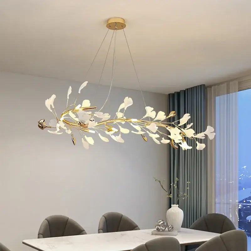 Elegant white and gold ginkgo branch ceramic chandelier featuring gold-toned branches and white leaf-like elements by decorbites