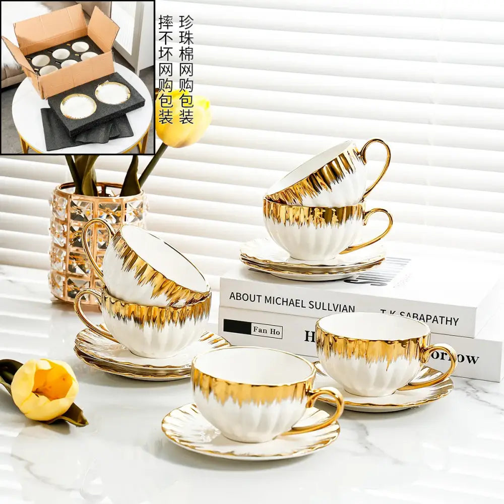 Elegant white and golden ceramic tea cup set with gold leaf detailing and fluted rims by decorbites golden ceramic