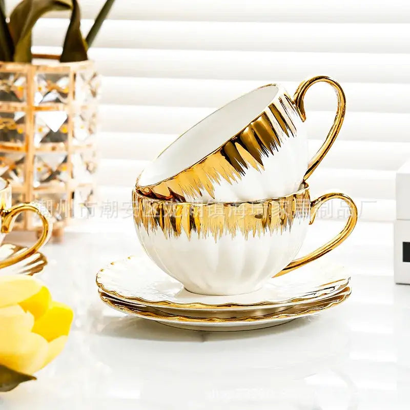 Elegant white and golden ceramic tea cup set with gold leaf detailing and fluted design by decorbites golden ceramic