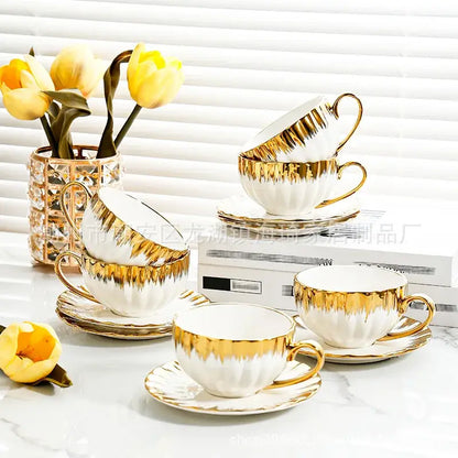 Elegant white and golden ceramic tea cup set with gold leaf accents and fluted rims by decorbites golden ceramic