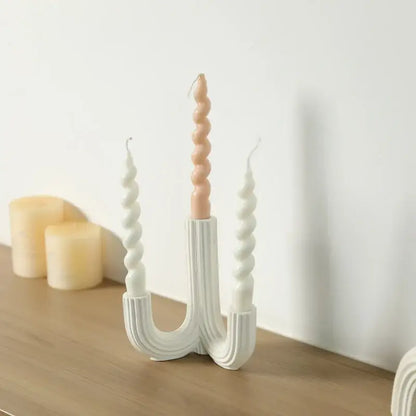 Elegant white ceramic candlestick holder with three twisted arms holding peach and white spiral candles for dining room decorbites elegant white