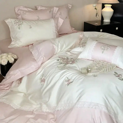Elegant white flowers embroidery lace bedding set featuring an ivory satin duvet cover with pink accents and floral decorbites flowers embroidery