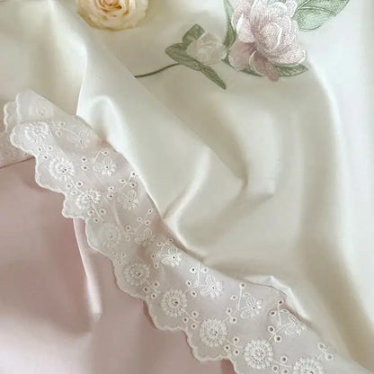 Elegant white flowers embroidery lace bedding set featuring delicate floral patterns and scalloped edges on satin fabric