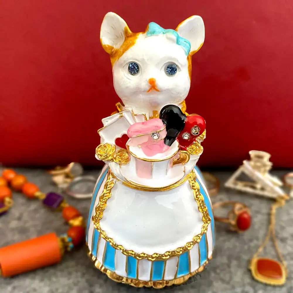 Elegant white porcelain cat jewelry trinket box with blue eyes, turquoise bow, and gold-trimmed striped apron decorbites elegant cat