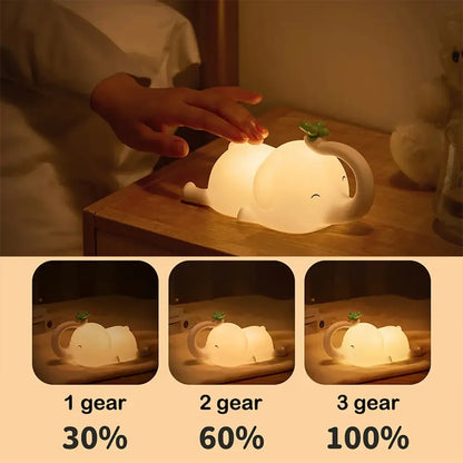 A soft white decorbites elephant silicone night light with a green clover leaf and three brightness settings for bedroom decor