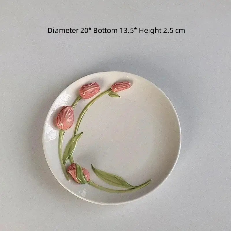 A white embossed tulip ceramic plate with 3d pink floral design on rim for decorbites tulip ceramic coffee set
