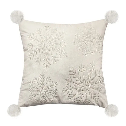 Cream-colored pillow cover with silver embroidered snowflakes and white pom-poms for decorbites embroidered christmas pillow decor