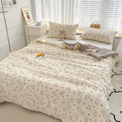 Cream-colored quilted double gauze comforter with black-outlined teddy bears and stars featuring rabbit print design