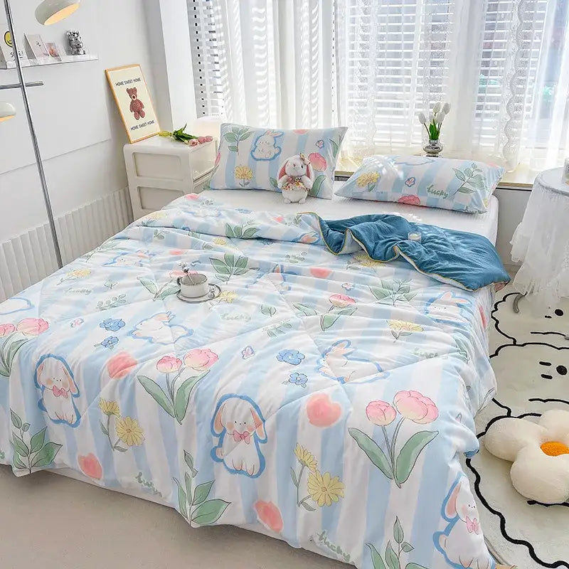 Embroidered double gauze rabbit print quilt featuring light blue and white stripes with pastel floral tulips and daisies