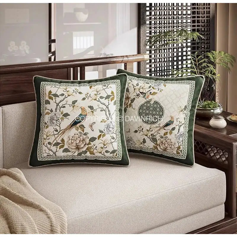 Two dark green velvet cushion covers with intricate embroidered dream floral birds motifs on cream for living room decorbites