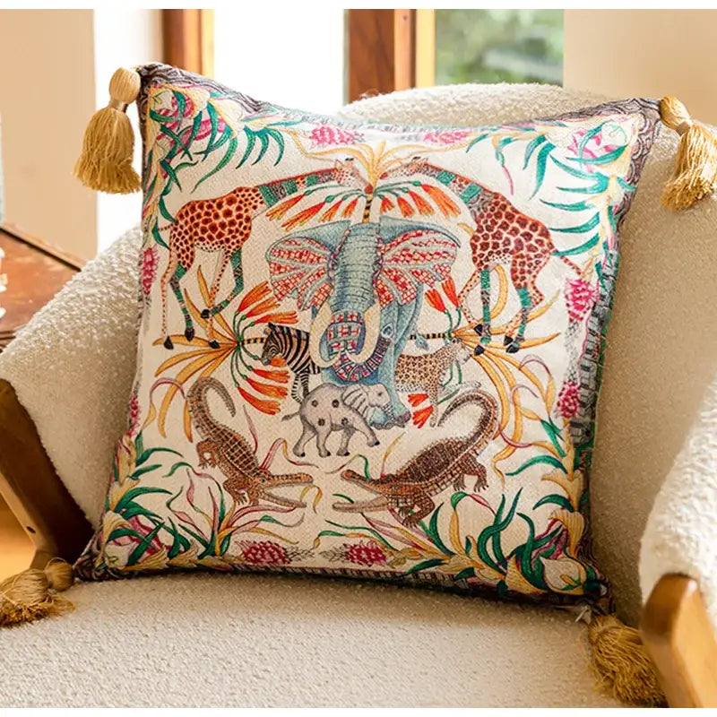 Embroidered elephant jungle paradise throw pillow with vibrant animal embroidery on off-white fabric and golden tassels decorbites elephant jungle decor