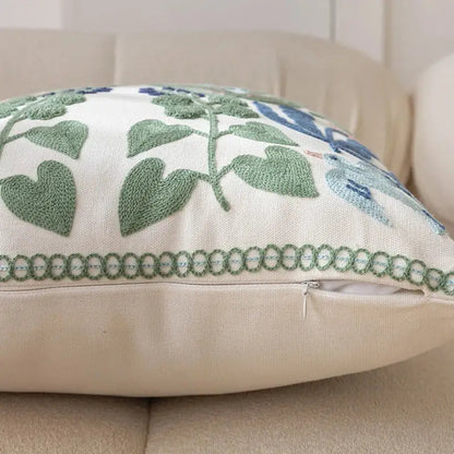 Cream-colored office cushion pillowcase with intricate green and blue embroidered foliage design for office use