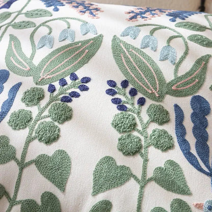 Cream-colored office cushion pillowcase with intricate embroidered floral patterns in green blue and pink for office use