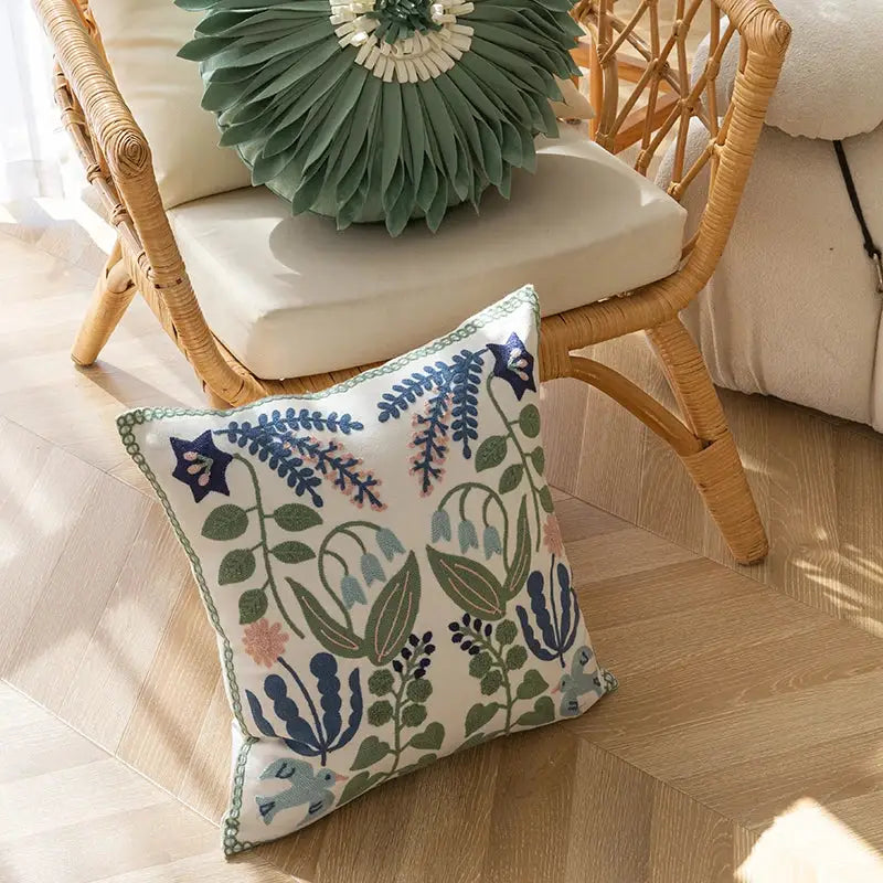 Embroidered floral bird white office cushion pillowcase with intricate blue green pink and gray patterns on white base