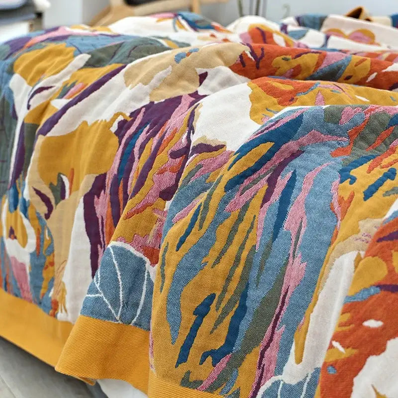 Vibrant multicolored embroidered floral and leaf decorbites cotton gauze bedroom blanket in blue and cream tones