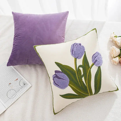 Cream-colored pillowcase cover with embroidered purple tulip and green leaf design accented by a green border