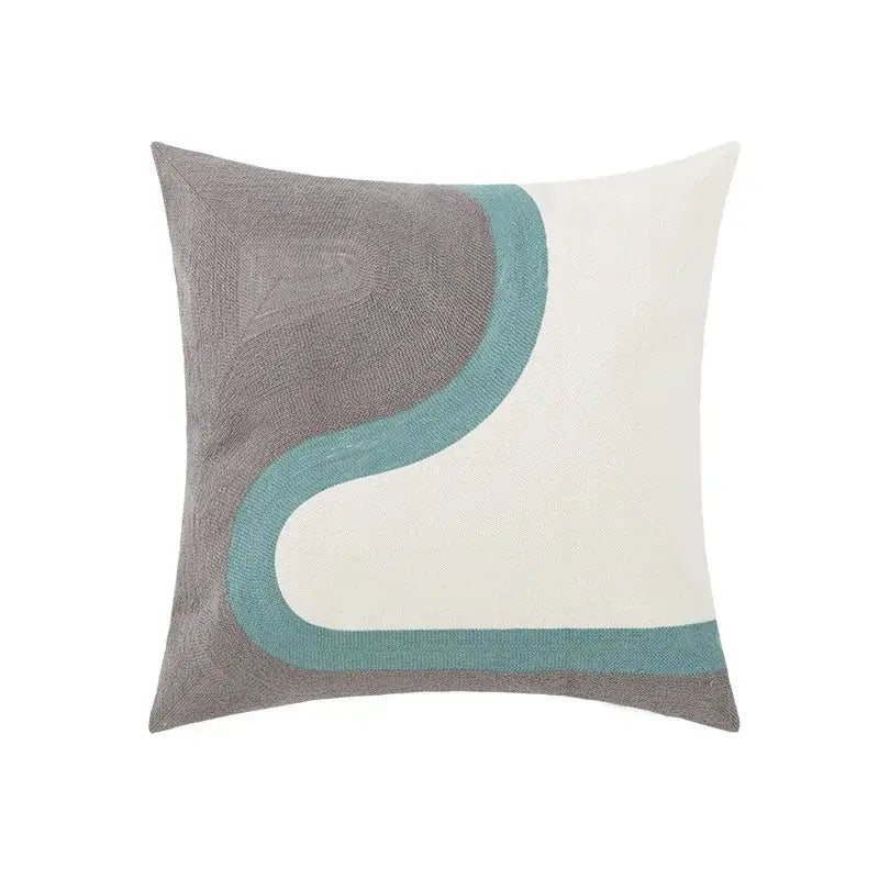 A square pillow cover with a modern abstract design in gray cream and teal complementing daisy yellow floral decor