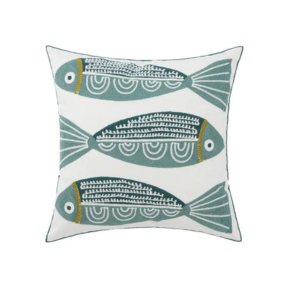 White cushion pillow cover with three embroidered teal fish featuring white and gold detailing for living room decor