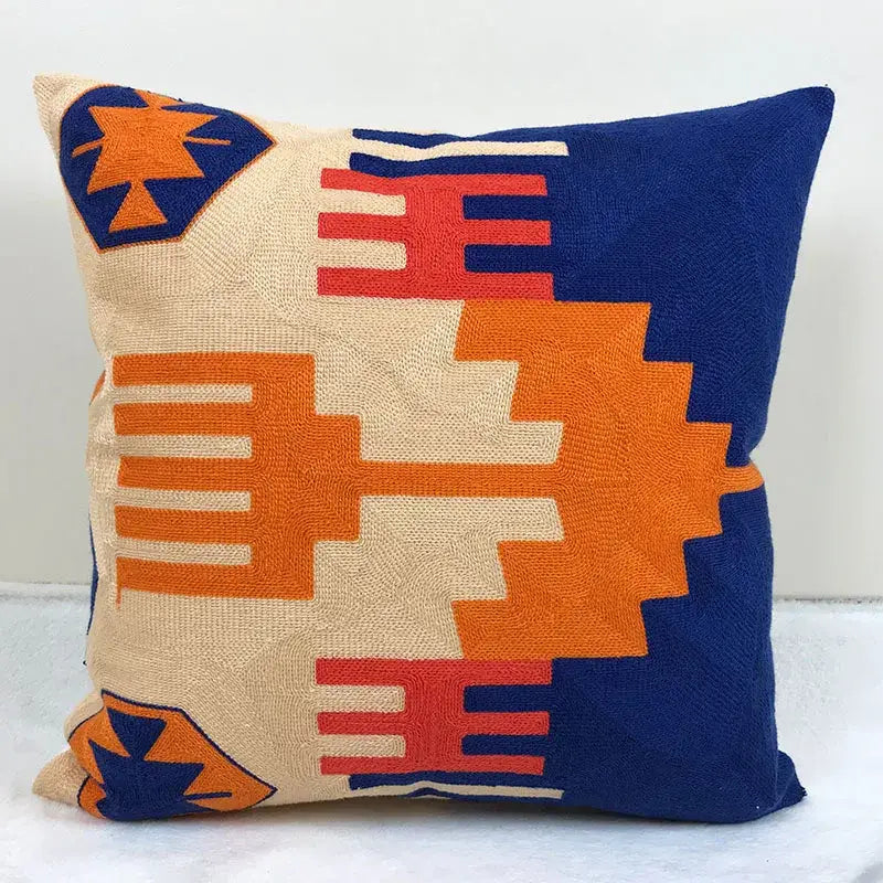 Vibrant embroidered kilim style cushion cover with bold orange red navy blue and cream geometric pattern for living room