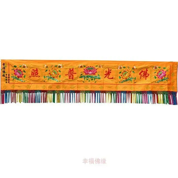 A vibrant orange embroidered home temple banner with pink lotus flowers red Chinese characters and colorful fringe decorbites Buddhist worship set