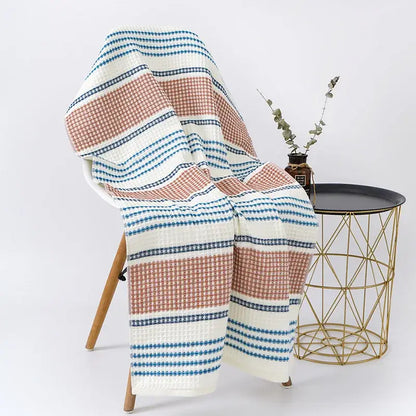 A decorbites cotton bath towel with embroidered honeycomb linen texture in white and blue with a cozy throw blanket pattern