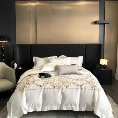 White satin egyptian cotton bedding set with gold floral embroidery and quilted black headboard backdrop