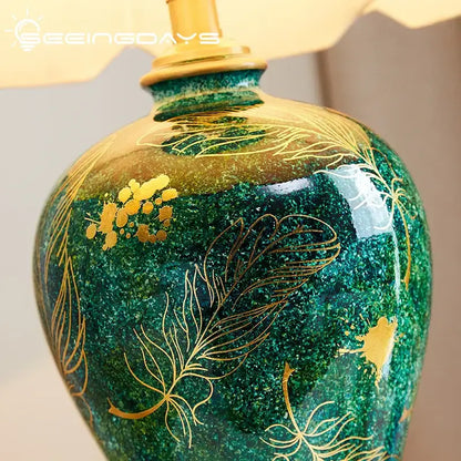 Emerald green ceramic table lamp with decorbites golden leaf floral patterns perfect for living room decor