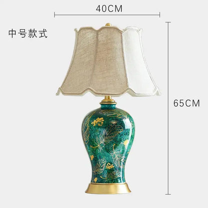 Emerald green floral ceramic table lamp with decorbites golden leaf patterns and beige fabric shade for living room decor