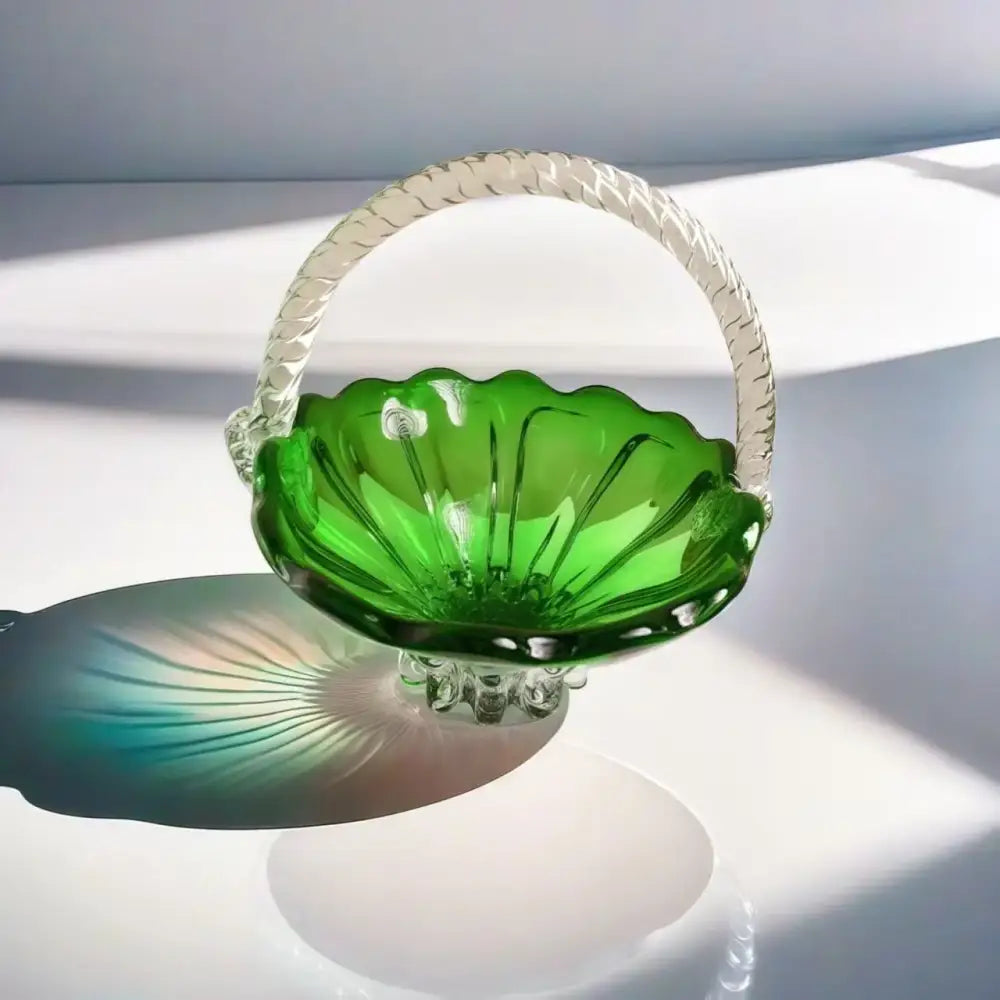 Emerald green glass fruit basket with decorbites crystal handle and scalloped edges on reflective glass tray