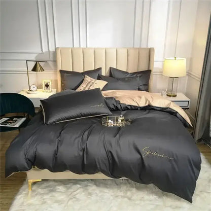 Dark gray satin duvet cover set with gold cursive embroidery paired with emerald green and pink egyptian cotton bedding set