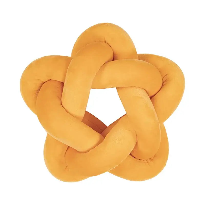 A mustard-yellow velvet lumbar cushion shaped like an interlocking knot for decorbites green star bedroom decor