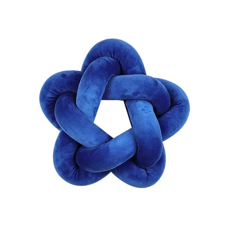 A royal blue velvet knot-shaped lumbar cushion with a star-like pattern for decorbites green star bedroom decor
