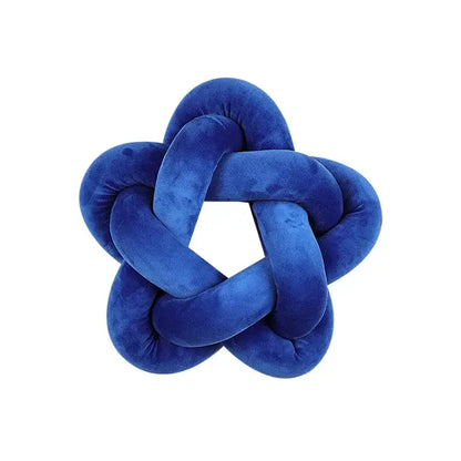 A royal blue velvet knot-shaped lumbar cushion with a star-like pattern for decorbites green star bedroom decor