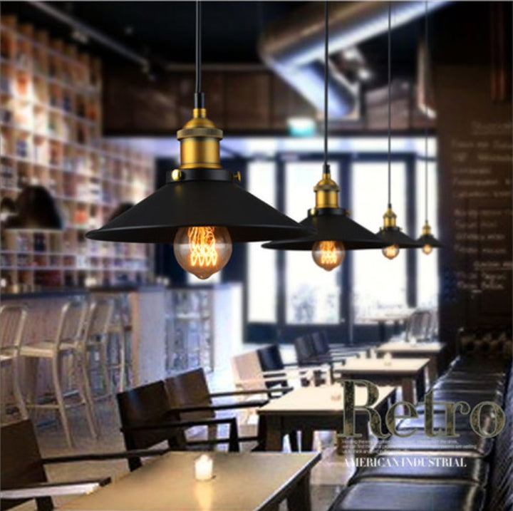 Engineering chandelier featuring a black and gold iron chandelier with vintage edison bulbs inspired by american countryside design