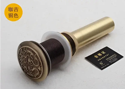 Engraved brass bathroom sink pop up drain stopper with intricate design and white rubber seal for decorbites brass bathroom