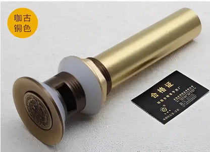 Engraved brass bathroom sink pop up drain stopper with decorative circular plate and metallic finish for brass bathroom sink decorbites