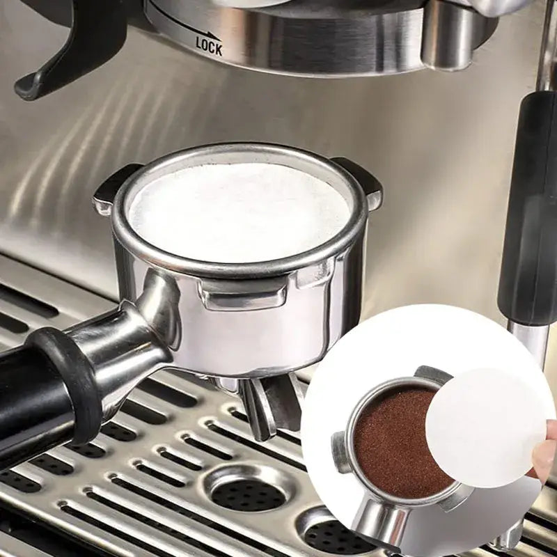 Stainless steel espresso portafilter with frothy milk layer and close-up of ground coffee using decorbites coffee filter papers