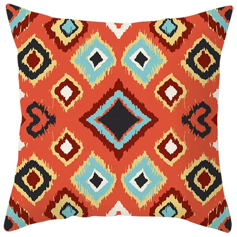 Vibrant orange pillow cover with bold ethnic bohemian geometric pattern in turquoise black and cream for living room decorbites decor